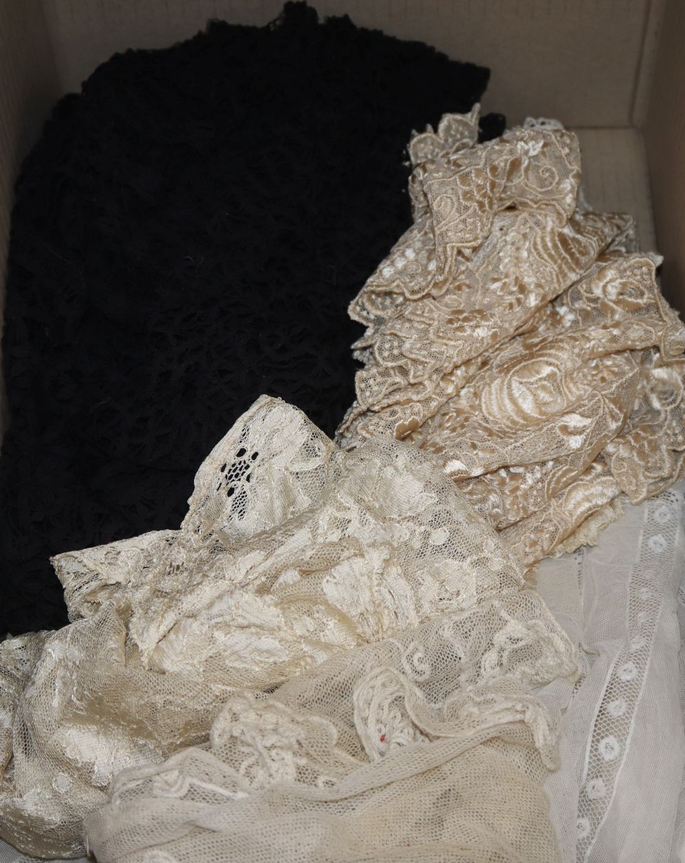 An Edwardian ladies lace blouse, a black bobbin lace shawl, a cream silk machine lace shawl and mixed trimmings